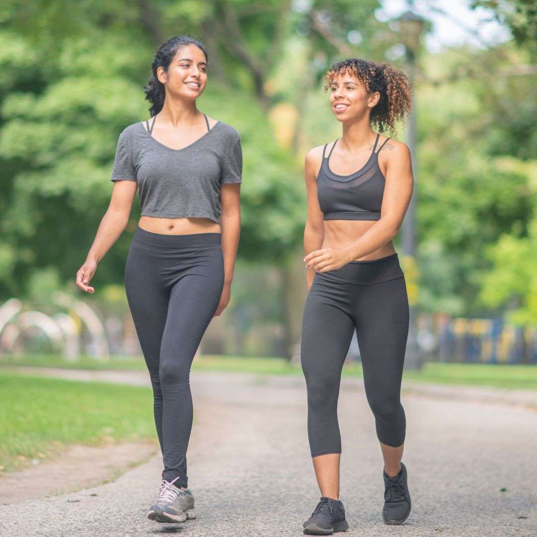 two woman walking and smiling