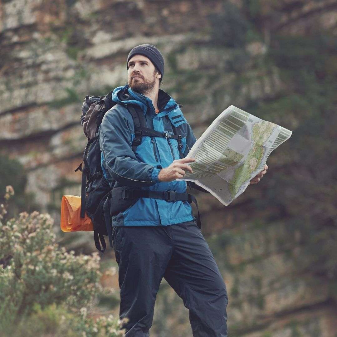 Hiking man with map in hand