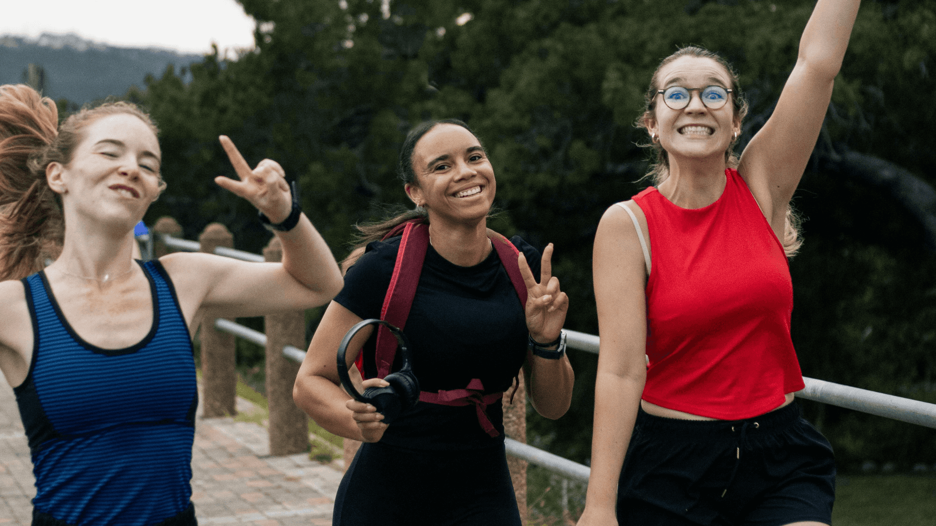 Three women smile while they run together