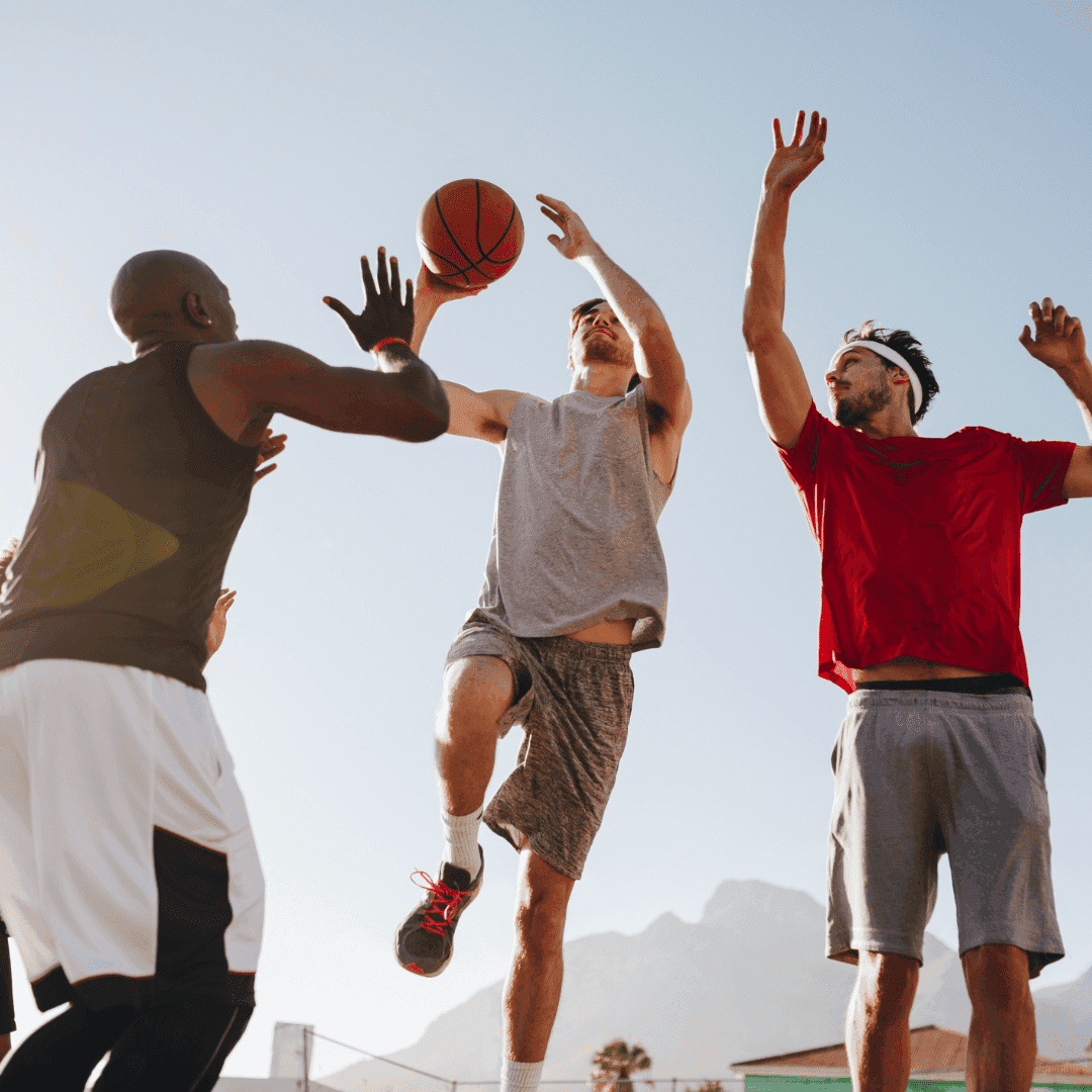 Three men playing basketball